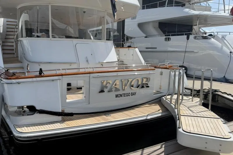 Slide: The Image of Luxury Crescent Custom Yacht, 2000 model, docked with "Favor" and "Montego Bay" on stern. - 58