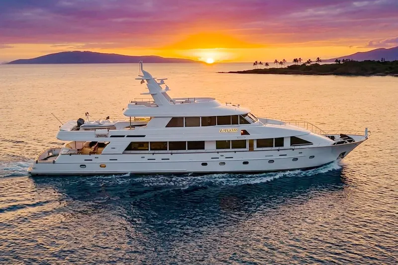 The Image of Luxurious 2000 Crescent Custom Yacht cruising at sunset near tropical island. - 0