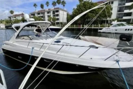 The Image of 2007 Regal Commodore 3760 IB yacht docked in marina with palm trees and buildings. - 0
