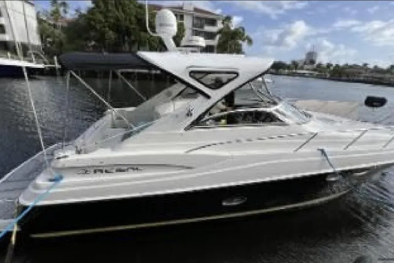 Slide: The Image of 2007 Regal Commodore 3760 IB yacht docked on a calm waterfront. - 12