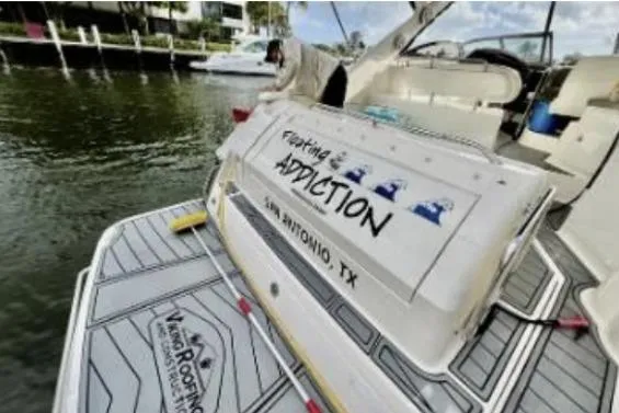 Slide: The Image of 2007 Regal Commodore 3760 IB boat docked, featuring custom graphics and San Antonio, TX label. - 5
