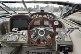 Slide: The Image of 2007 Regal Commodore 3760 IB boat dashboard with steering wheel and control panel. - 9