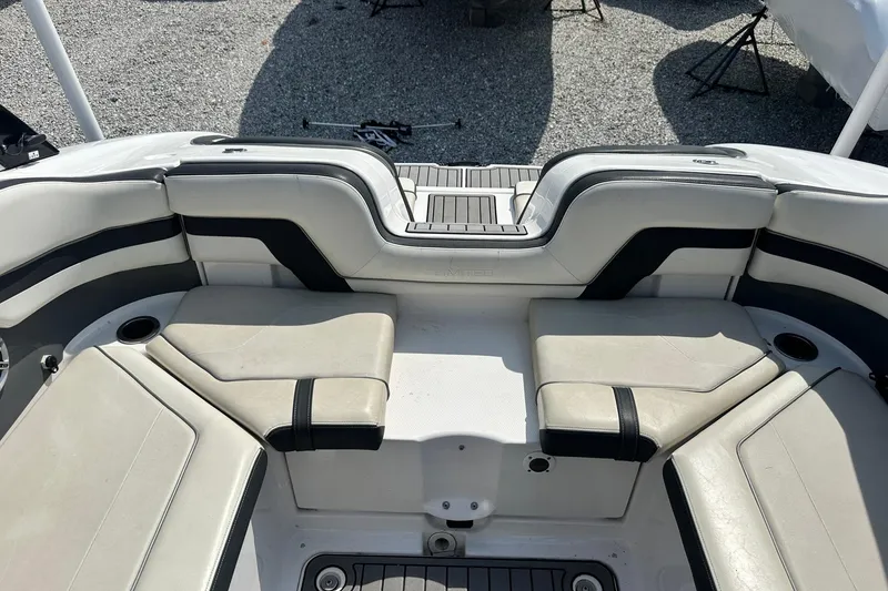 Slide: The Image of 2016 Yamaha 242 Limited S boat interior with cushioned seating and cup holders. - 10