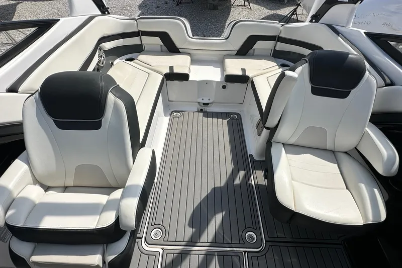 Slide: The Image of 2016 Yamaha 242 Limited S boat interior with white and black seating. - 11