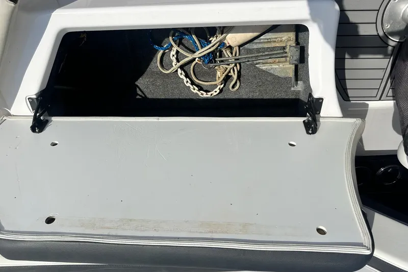 Slide: The Image of Open storage compartment on 2016 Yamaha 242 Limited S boat, containing ropes and anchor. - 15