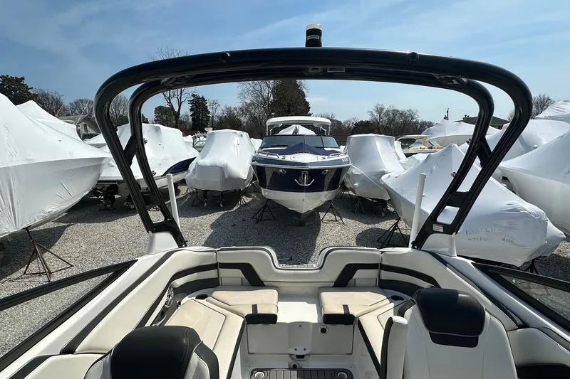 Slide: The Image of 2016 Yamaha 242 Limited S boat in storage, surrounded by covered boats. - 17