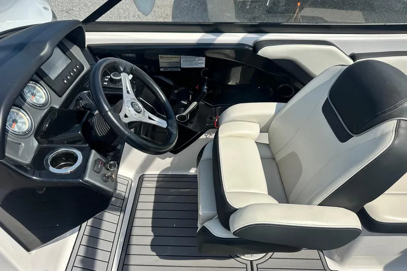 Slide: The Image of 2016 Yamaha 242 Limited S boat cockpit with steering wheel and captain's seat. - 18