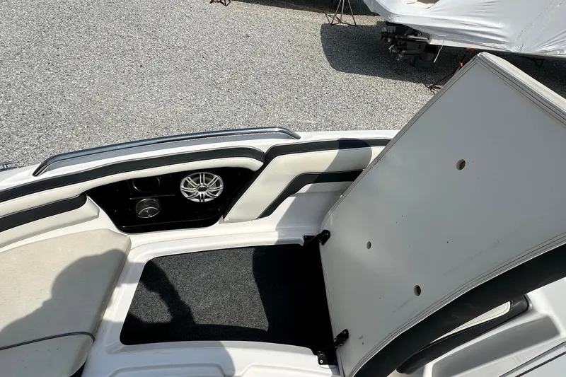 Slide: The Image of 2016 Yamaha 242 Limited S boat interior with open storage compartment and speaker. - 28