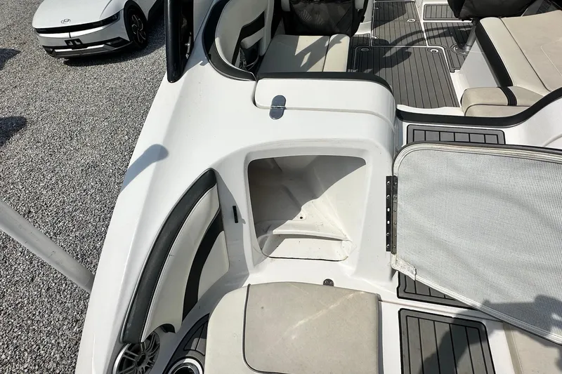 Slide: The Image of 2016 Yamaha 242 Limited S boat interior with open storage compartment and seating. - 8