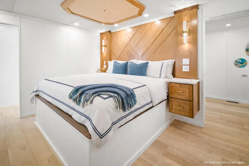 Slide: The Image of Luxurious bedroom interior on Sumerset Luxe III Show Boat, 2026 model, featuring elegant bedding and wood accents. - 11