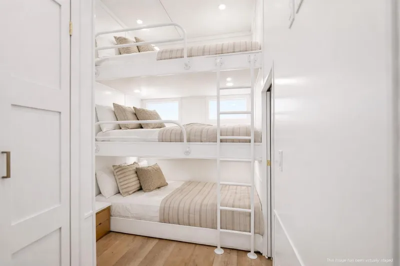 Slide: The Image of Luxurious 2026 Sumerset Luxe III Show Boat bedroom with triple bunk beds and modern decor. - 12