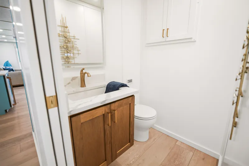 Slide: The Image of Modern bathroom on 2026 Sumerset Luxe III Show Boat with elegant fixtures and wooden cabinetry. - 18