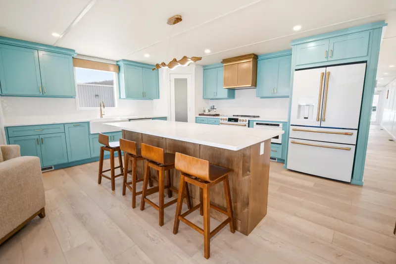 Slide: The Image of Modern kitchen in 2026 Sumerset Luxe III Show Boat with turquoise cabinets and island seating. - 3