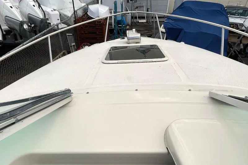 Slide: The Image of 2002 Sea Ray 225 Weekender boat deck with hatch, docked in marina. - 4