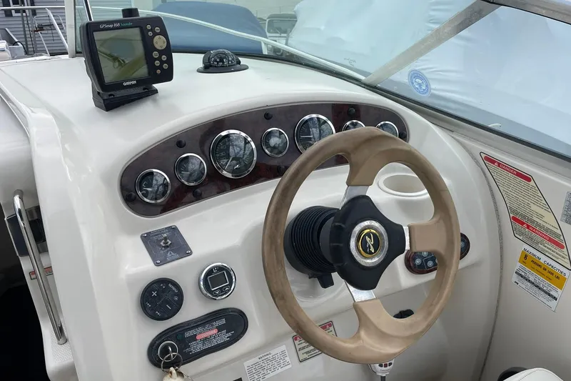 Slide: The Image of 2002 Sea Ray 225 Weekender dashboard with steering wheel and GPS navigation system. - 7