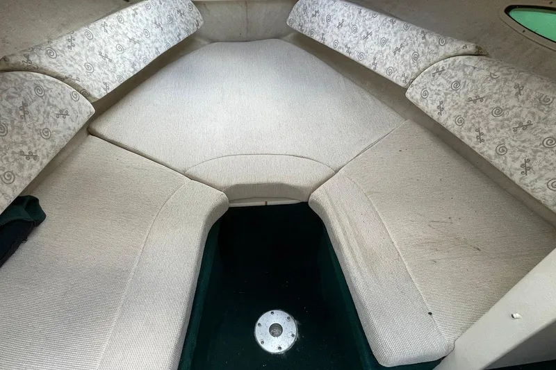 Slide: The Image of Interior cabin of a 2002 Sea Ray 225 Weekender boat with cushioned seating. - 8