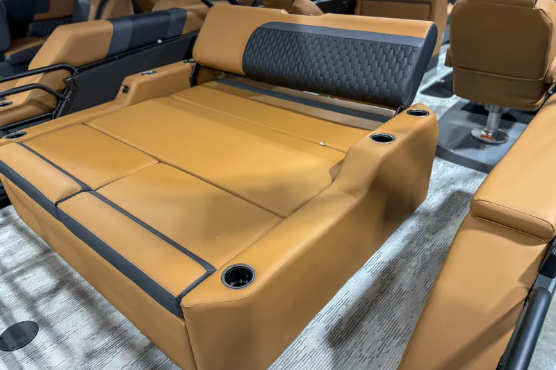 Slide: The Image of Luxurious interior seating of 2026 Sylvan L3 ULZ boat with tan upholstery and cup holders. - 10