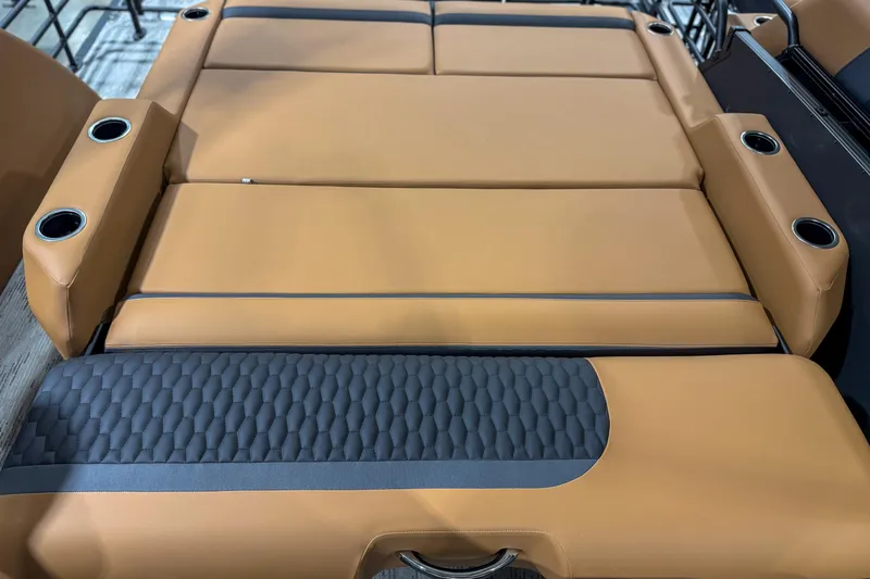 Slide: The Image of Luxurious tan seating with cup holders in 2026 Sylvan L3 ULZ boat interior. - 11