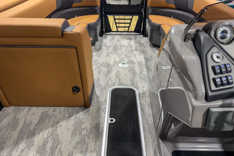 Slide: The Image of Interior of 2026 Sylvan L3 ULZ boat with tan seating and modern dashboard. - 13