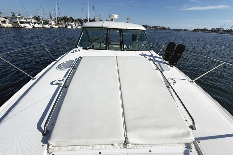 Slide: The Image of 2007 Cruisers Yachts 390 Express Coupe on calm water, showcasing spacious deck and marina backdrop. - 15