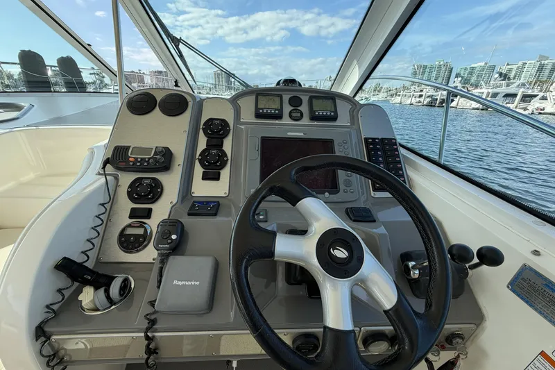Slide: The Image of Cockpit of 2007 Cruisers Yachts 390 Express Coupe with steering wheel and navigation controls. - 16