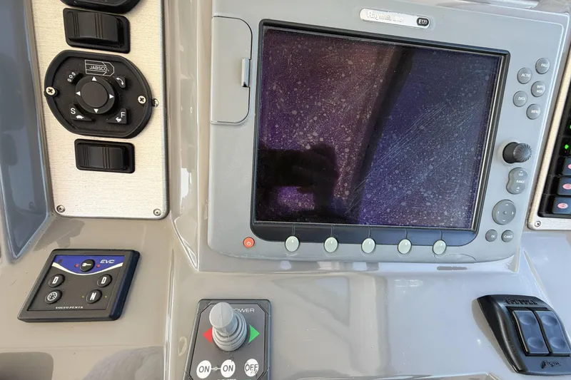 Slide: The Image of Control panel of 2007 Cruisers Yachts 390 Express Coupe with navigation screen and controls. - 17