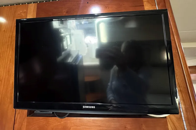 Slide: The Image of Samsung TV mounted on wooden panel inside 2007 Cruisers Yachts 390 Express Coupe. - 25