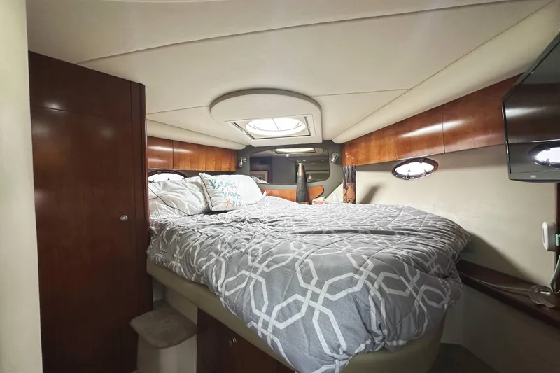 Slide: The Image of Luxurious cabin interior of 2007 Cruisers Yachts 390 Express Coupe with cozy bedding. - 28