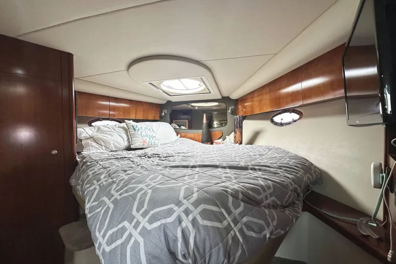 Slide: The Image of Luxurious cabin interior of 2007 Cruisers Yachts 390 Express Coupe with cozy bedding. - 29