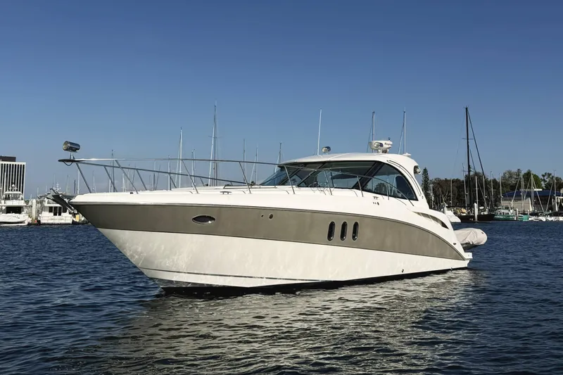 Slide: The Image of 2007 Cruisers Yachts 390 Express Coupe on calm water, marina background. - 3