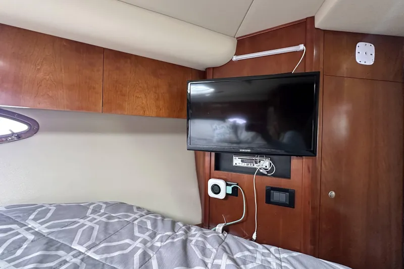 Slide: The Image of Interior of 2007 Cruisers Yachts 390 Express Coupe with TV and wooden cabinetry. - 30