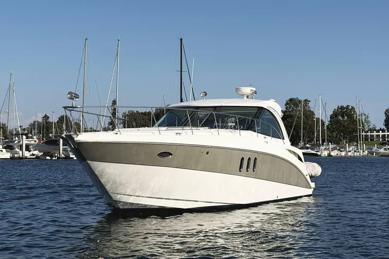 Slide: The Image of 2007 Cruisers Yachts 390 Express Coupe on calm water, marina background. - 4