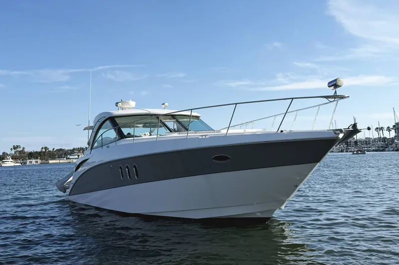Slide: The Image of 2007 Cruisers Yachts 390 Express Coupe on calm water, showcasing sleek design and luxury. - 5