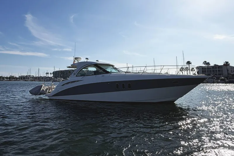 Slide: The Image of 2007 Cruisers Yachts 390 Express Coupe on calm water, marina background. - 6