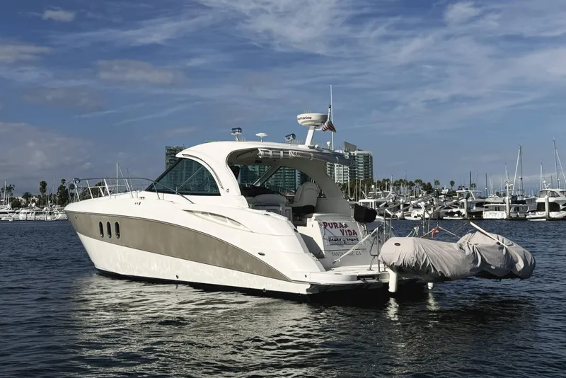 Slide: The Image of 2007 Cruisers Yachts 390 Express Coupe docked in a marina under a clear sky. - 7