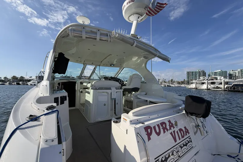 Slide: The Image of 2007 Cruisers Yachts 390 Express Coupe docked in marina, sunny day, "Pura Vida" on stern. - 8