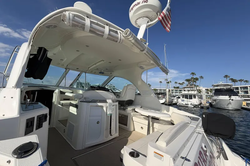 Slide: The Image of 2007 Cruisers Yachts 390 Express Coupe docked at marina, showcasing spacious cockpit. - 9