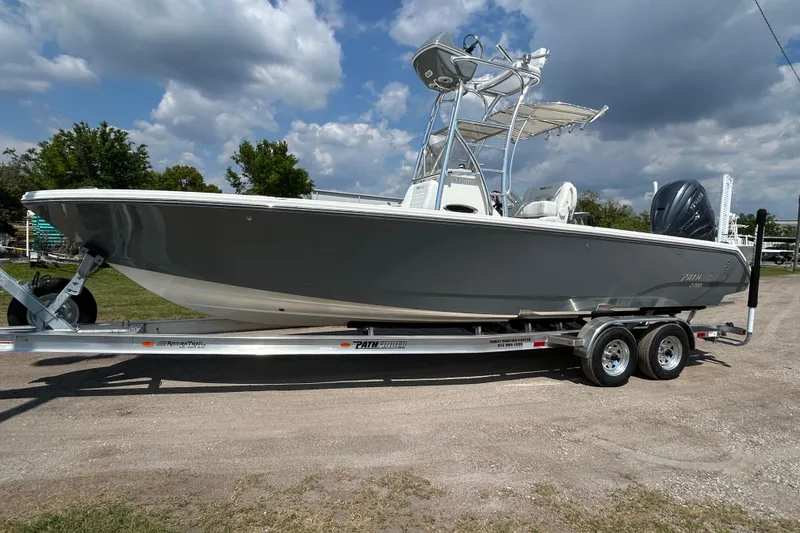 The Image of 2026 Pathfinder 2700 Open boat on trailer under cloudy sky. - 0