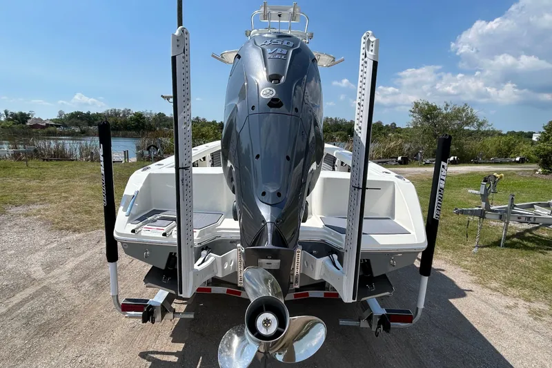 Slide: The Image of 2026 Pathfinder 2700 Open boat with powerful outboard motor, parked on a sunny day. - 4