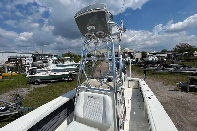 Slide: The Image of 2026 Pathfinder 2700 Open boat with T-top, parked outdoors under a cloudy sky. - 7