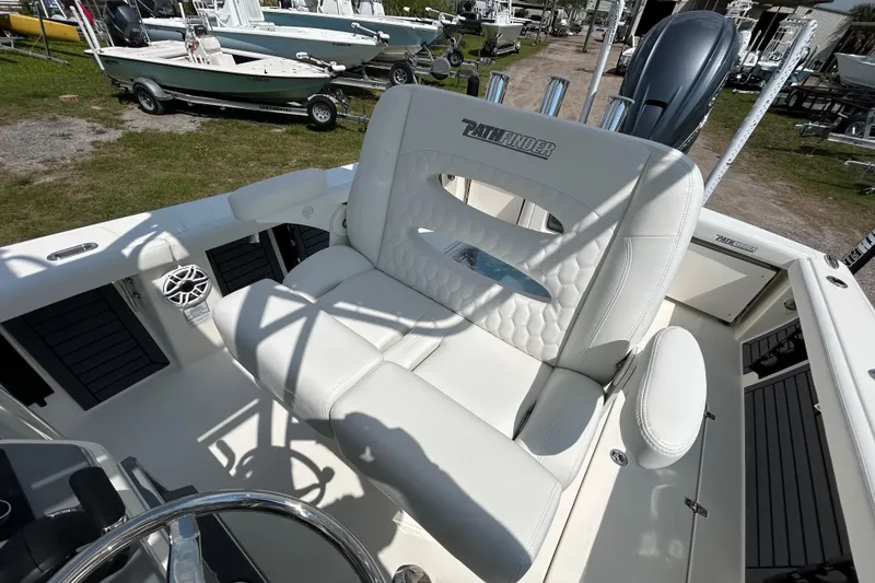 Slide: The Image of 2026 Pathfinder 2700 Open boat interior with white seating and steering wheel. - 9