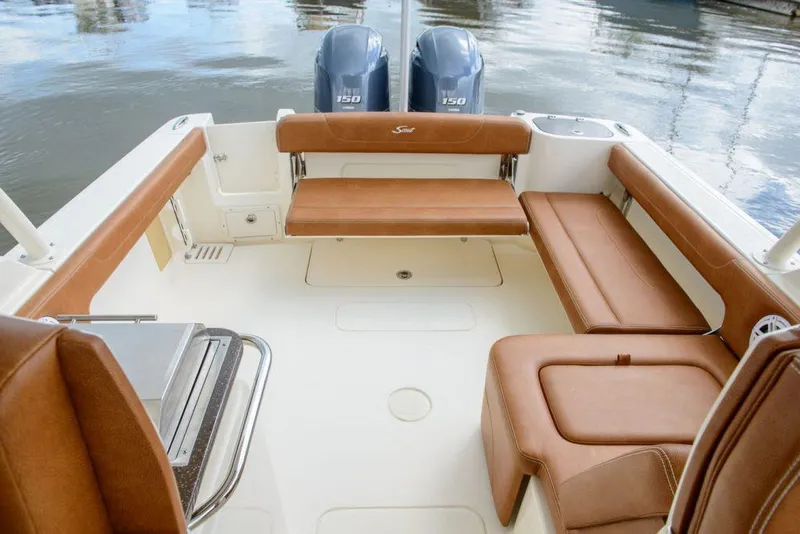 Slide: The Image of Manufacturer Provided Image: 2025 Scout 255 Dorado boat interior with brown leather seating and twin engines. - 14