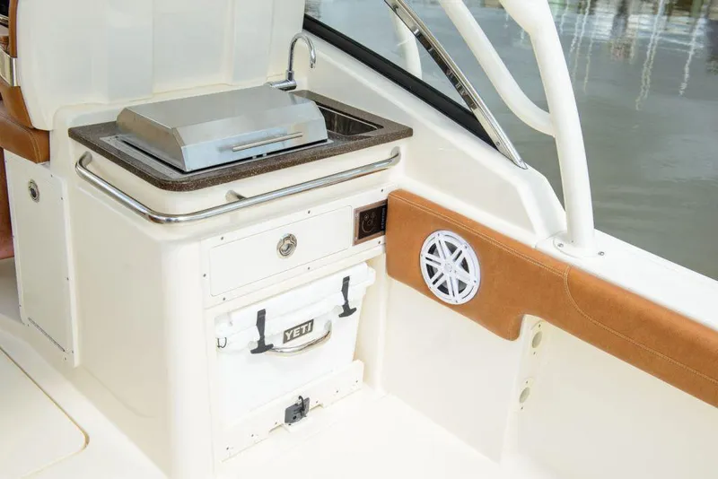 Slide: The Image of Manufacturer Provided Image: 2025 Scout 255 Dorado boat interior with grill and Yeti cooler. - 15
