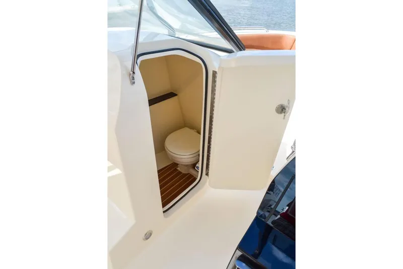 Slide: The Image of Manufacturer Provided Image: 2025 Scout 255 Dorado boat interior with compact marine toilet. - 20