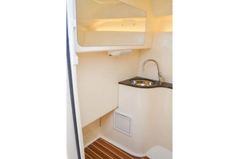 Slide: The Image of Manufacturer Provided Image: 2025 Scout 255 Dorado boat interior with sink and wooden flooring. - 22