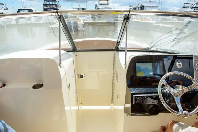 Slide: The Image of Manufacturer Provided Image: 2025 Scout 255 Dorado boat cockpit with steering wheel and navigation display. - 6