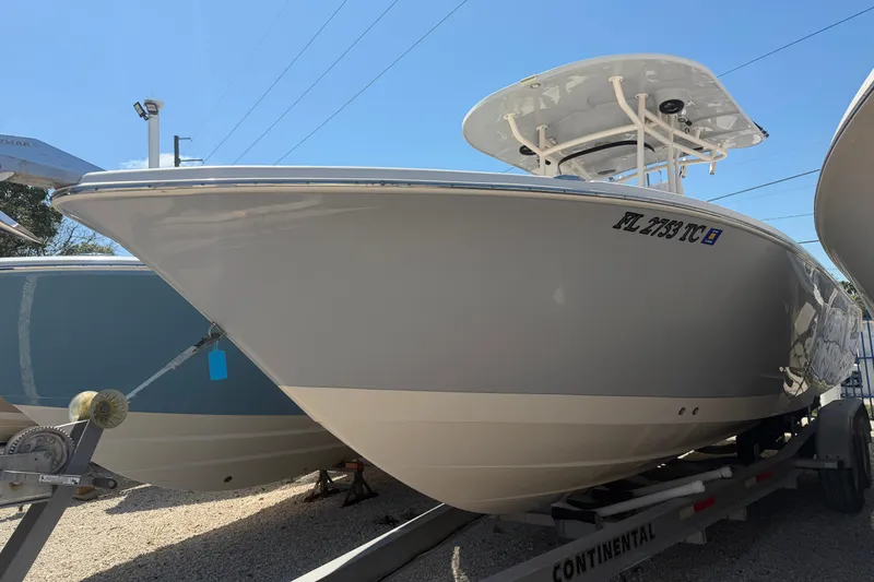 The Image of 2021 Sea Chaser 30 HFC CC boat on trailer, side view under clear sky. - 1