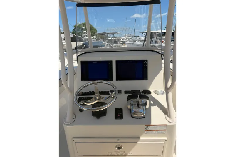 Slide: The Image of 2021 Sea Chaser 30 HFC CC boat console with dual screens and steering wheel. - 12
