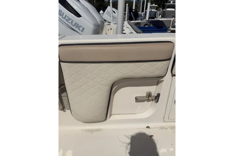 Slide: The Image of 2021 Sea Chaser 30 HFC CC boat interior with quilted upholstery and Suzuki engine. - 9