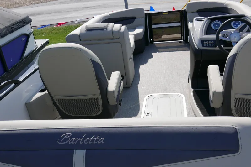 Slide: The Image of 2023 Barletta Cabrio 22UC boat interior with seating and steering console. - 12